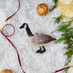 Craftspring’s Canada Goose Ornament — needle felted with soft wings and beaded eyes — displayed on snowy ground with golden walnuts, a festive holiday scene full of warmth, heirloom beauty, and Christmas gifting cheer, ethically crafted by artisans using sustainable wool.