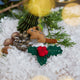 Craftspring’s handmade Woodland Minis Advent Calendar — close-up of two mini ornaments, a chipmunk and holly, displayed among evergreens and snow, highlighting the intricate woodland Christmas details, ethically crafted by artisans using sustainable wool.