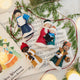 Handmade felt Carolers Set of 5 ornaments from Craftspring, featuring four singers and one clarinet player dressed in vintage clothes, with applique and embroidered snow at their feet — sweet-faced holiday decor that can stand on a mantle or hang on a Christmas tree, ethically crafted by artisans using sustainable wool.