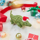 Craftspring’s Santa Alligator Ornament — felt alligator with a beautiful face and embroidered and beaded back ridges — styled among mini presents and baubles, evoking festive warmth, playful holiday charm, and heirloom-quality Christmas gifting, ethically crafted by artisans using sustainable wool.