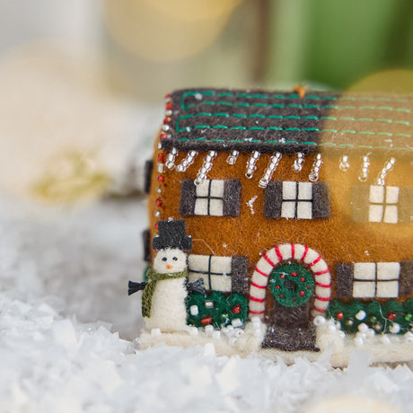 Craftspring’s Christmas House Ornament — felt house with intricate beading and embroidery — close-up showing the snowman in the yard, highlighting whimsical holiday details and heirloom-quality Christmas charm, ethically crafted by artisans using sustainable wool.