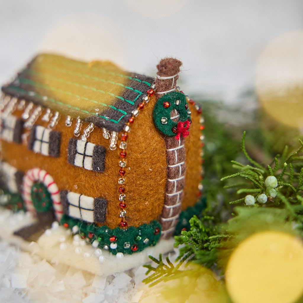 Craftspring’s Christmas House Ornament — felt house with detailed applique and beading — close-up showing the chimney with a wreath, capturing festive charm, cozy holiday spirit, and heirloom-quality gifting, ethically crafted by artisans using sustainable wool.