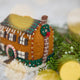 Craftspring’s Christmas House Ornament — felt house with detailed applique and beading — close-up showing the chimney with a wreath, capturing festive charm, cozy holiday spirit, and heirloom-quality gifting, ethically crafted by artisans using sustainable wool.