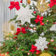 Craftspring’s Paper Snowflakes Christmas Ornaments — Set of 2, large white snowflakes with intricate cutout patterns — displayed on a Christmas tree, adding festive and elegant holiday decoration, ethically handmade by artisans from recycled cotton waste.