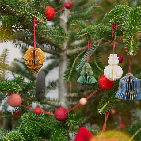 Craftspring’s Classic Christmas Honeycomb Paper Mini Ornaments — Set of 4, displayed on a Christmas tree, showcasing the snowman, bell, pinecone, and tree with gold sparkly edges, handmade by artisans from recycled cotton waste, adding festive holiday warmth.