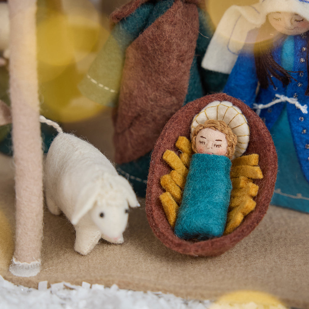 Nativity Barn showing baby Jesus in the manger with the Holy Family and a sheep — handmade felt with intricate details, designed to display Craftspring’s Holy Night Nativity Scene, ethically crafted by artisans using sustainable wool.