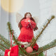 Craftspring’s Praying Angel Tree Topper - Light — felt angel wearing a red dress with white beads, embroidered and beaded wreath crown, and hands in prayer — displayed on top of a Christmas tree, evoking festive warmth, sweet holiday charm, and heirloom-quality Christmas gifting, ethically crafted by artisans using sustainable wool.
