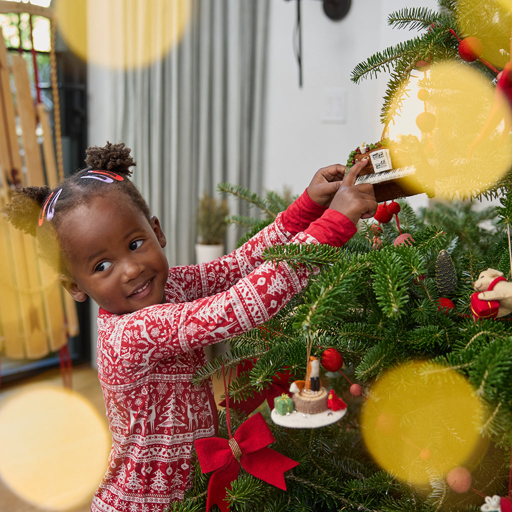 Craftspring’s Christmas Piano Ornament displayed on a Christmas tree for a festive scene — handmade felt holiday decor with intricate beaded and embroidered details, heirloom-quality ornament ethically crafted by artisans using sustainable wool.