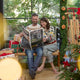 Craftspring’s NYC Holiday 100% Alpaca Sweater — ultra-soft crewneck made of sustainably harvested baby alpaca wool with intricate jacquard motifs of NYC icons like bagels, taxi cabs, and pigeons — ethically crafted by artisans in Peru. A couple wears the heirloom-quality sweaters in a festive holiday setting, perfect for Christmas warmth and gifting.