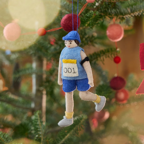 Craftspring’s Marathon Runner ornament — featuring a runner with race bib and armband, displayed on a Christmas tree for a festive holiday scene, perfect for holiday gifting, ethically crafted by artisans using sustainable wool.