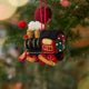 Craftspring’s Steam Engine Train Ornament displayed on a Christmas tree — felt black and red train with gold embroidery and beading, fluffy steam rising from the top, and a wreath on the back, adding festive warmth and whimsical charm — heirloom-quality Christmas decor, ethically crafted by artisans using sustainable wool.