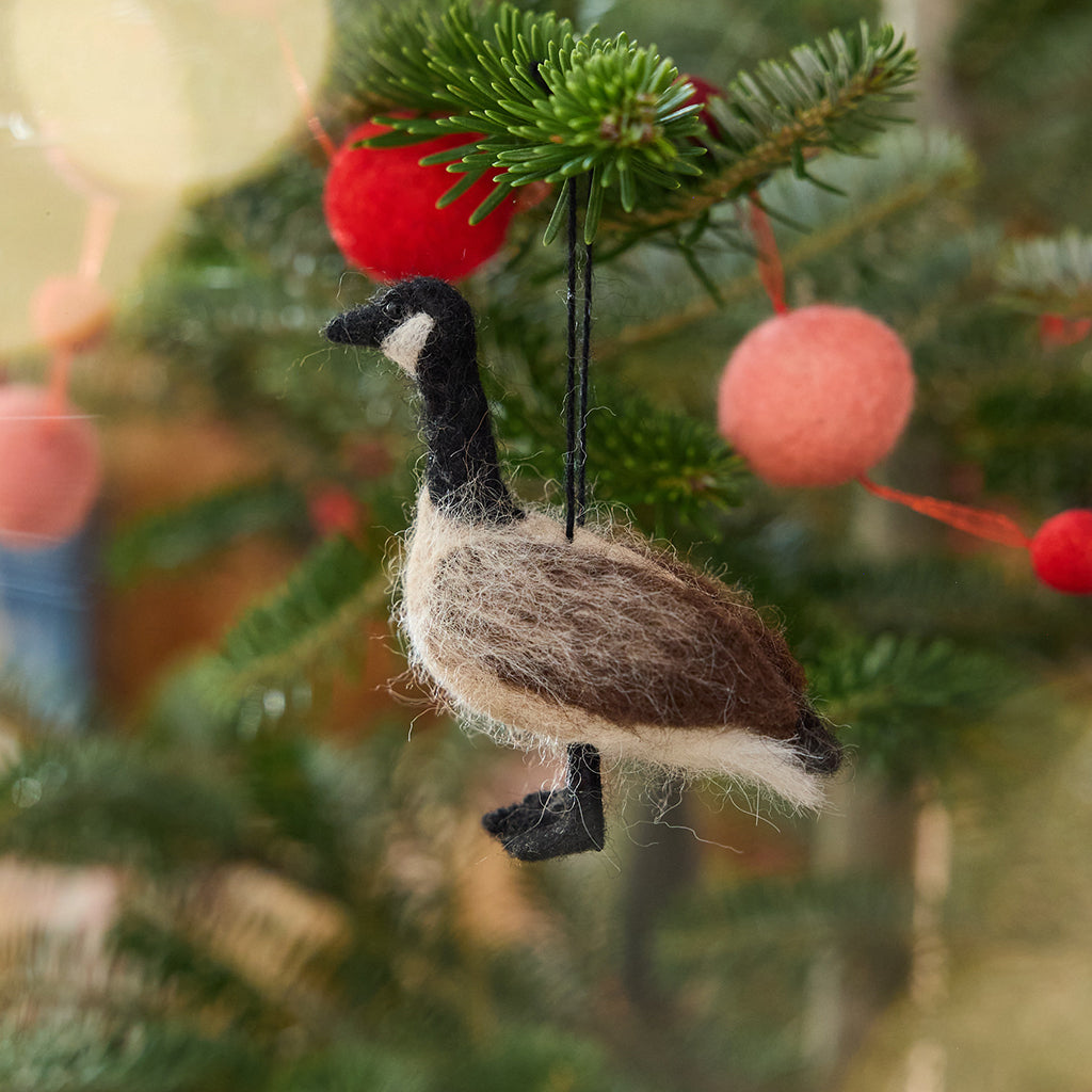 Craftspring’s Canada Goose Ornament displayed on a Christmas tree — with soft wings and delicate beaded eyes, this felt goose adds timeless beauty and festive warmth to your holiday traditions — heirloom-quality decor, ethically crafted by artisans using sustainable wool.