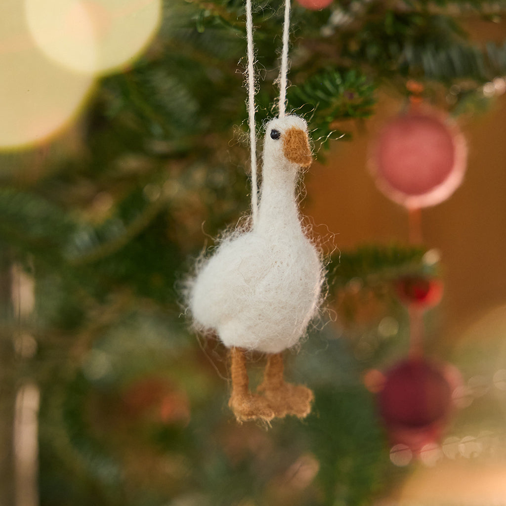 Craftspring’s Goose Ornament displayed on a Christmas tree — with fluffy felted feathers and delicate beaded eyes, this ornament adds festive warmth and beauty to your holiday traditions — heirloom-quality Christmas decor, ethically crafted by artisans using sustainable wool.
