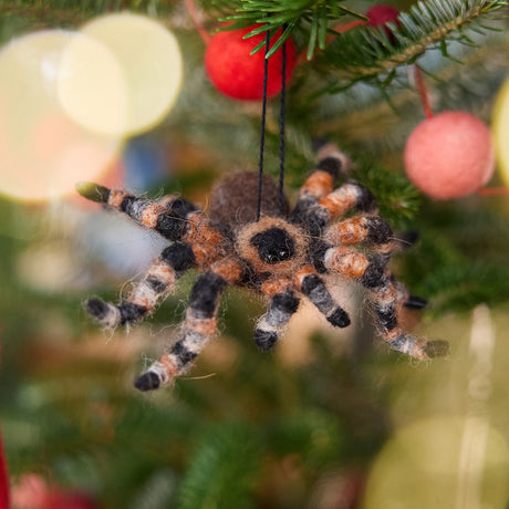 Craftspring’s Tarantula Ornament displayed on a Christmas tree—an unexpected, delightfully spooky touch for holiday gifting, ethically crafted by artisans using sustainable wool.