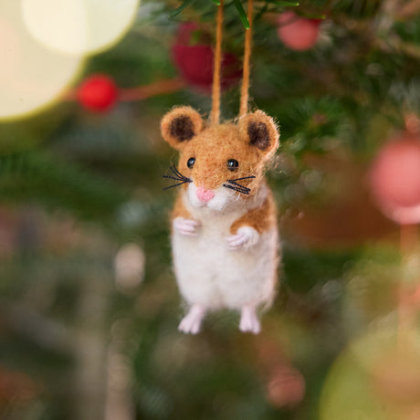 Craftspring’s handmade felt Hamster ornament displayed on a Christmas tree—needle-felted with sweet whiskers and tiny paws, adding playful holiday cheer and gifting warmth, ethically crafted by artisans using sustainable wool.