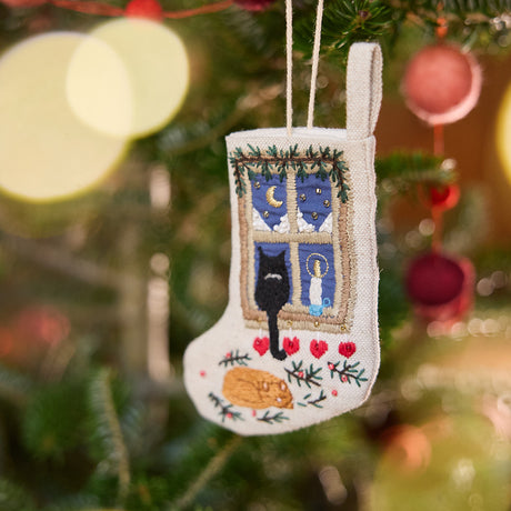 Craftspring’s Mini Holiday Cats Stocking ornament — made of linen with intricate beaded and embroidered details, displayed on a Christmas tree for a festive holiday scene, ethically crafted by artisans.