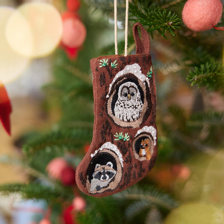 Craftspring’s Mini Woodland Stocking ornament — featuring intricate beaded and embroidered details, displayed on a Christmas tree for a festive holiday scene, ethically crafted by artisans.