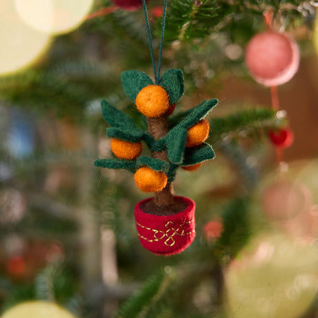 Clementine Tree Ornament from Craftspring displayed on a Christmas tree — handmade felt holiday decor in a red embroidered pot with eight clementines, a festive heirloom ornament symbolizing abundance, ethically crafted by artisans using sustainable wool.