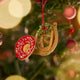 French Horn Ornament displayed on a Christmas tree — handmade felt ornament with golden embroidery, beading, and festive mistletoe, perfect for holiday gifting, ethically crafted by artisans using sustainable wool.