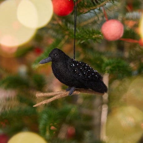 Craftspring’s Crow Ornament displayed on a Christmas tree — felt ornament of a crow perched on a branch with intricate beaded wings, perfect for Halloween, harvest, and holiday gifting, ethically crafted by artisans using sustainable wool.