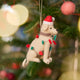 Craftspring’s Yellow Lab in Christmas Lights Ornament displayed on a Christmas tree — felt dog wrapped in Christmas lights and wearing a Santa hat, adding playful holiday charm and festive warmth — heirloom-quality Christmas decor, ethically crafted by artisans using sustainable wool.