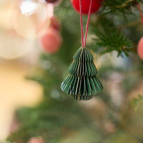 Craftspring’s tree honeycomb paper mini ornament with gold sparkly edges displayed on a Christmas tree — handmade by artisans from recycled cotton waste.