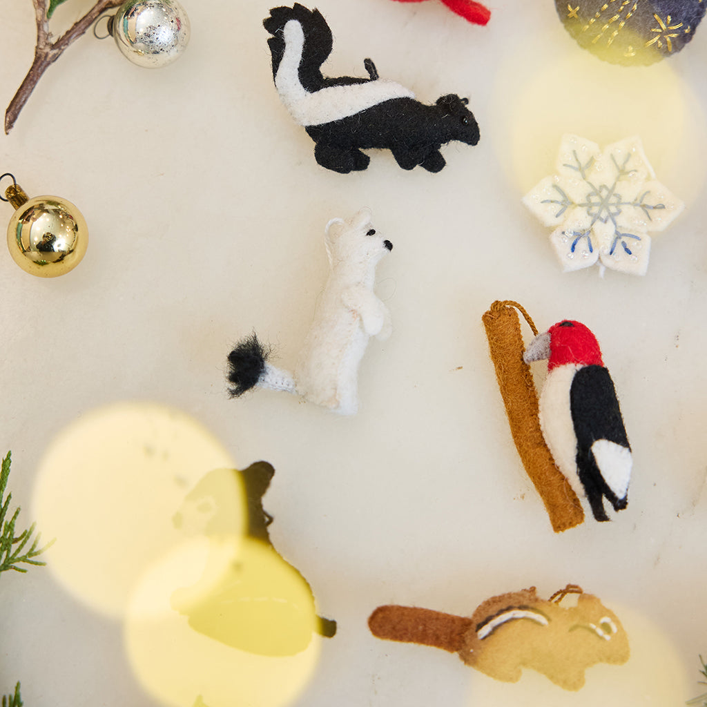 Close-up of Craftspring’s Woodland Minis Advent Calendar ornaments — showing the intricate embroidered and beaded details of the tiny woodland designs, heirloom-quality Christmas treasures ethically crafted by artisans using sustainable wool.