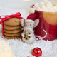 Craftspring’s Santa Mouse with Cookie Ornament — needle felted mouse with a cute face and whiskers, wearing a knitted Santa hat and holding a cookie — displayed on snow alongside cookies and hot cocoa, capturing cozy holiday charm, festive warmth, and heirloom-quality Christmas gifting, ethically crafted by artisans using sustainable wool.