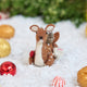 Craftspring’s Sitting Deer with Friends ornament — featuring a deer in the snow with a bunny, squirrel, and bird nestled around it, with intricate beaded snow and embroidered details — displayed in the snow with bobbles for a festive Christmas scene, ethically crafted by artisans using sustainable wool.