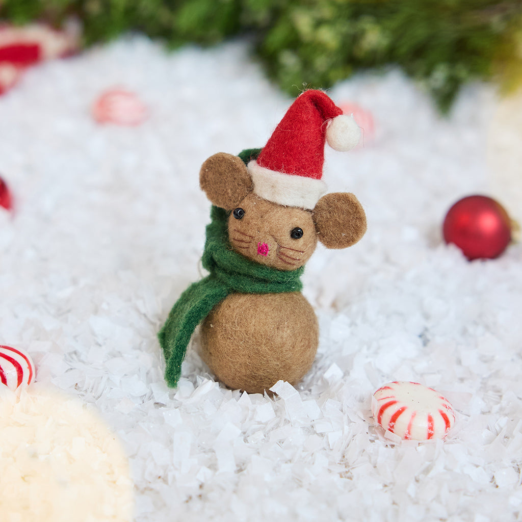 Craftspring’s Little Drop Santa Mouse Ornament — felt mouse made of felt balls, wearing a Santa hat and green scarf — displayed on snow with holiday baubles and peppermint candies, evoking festive cheer, playful Christmas spirit, and heirloom-quality gifting, ethically crafted by artisans using sustainable wool.