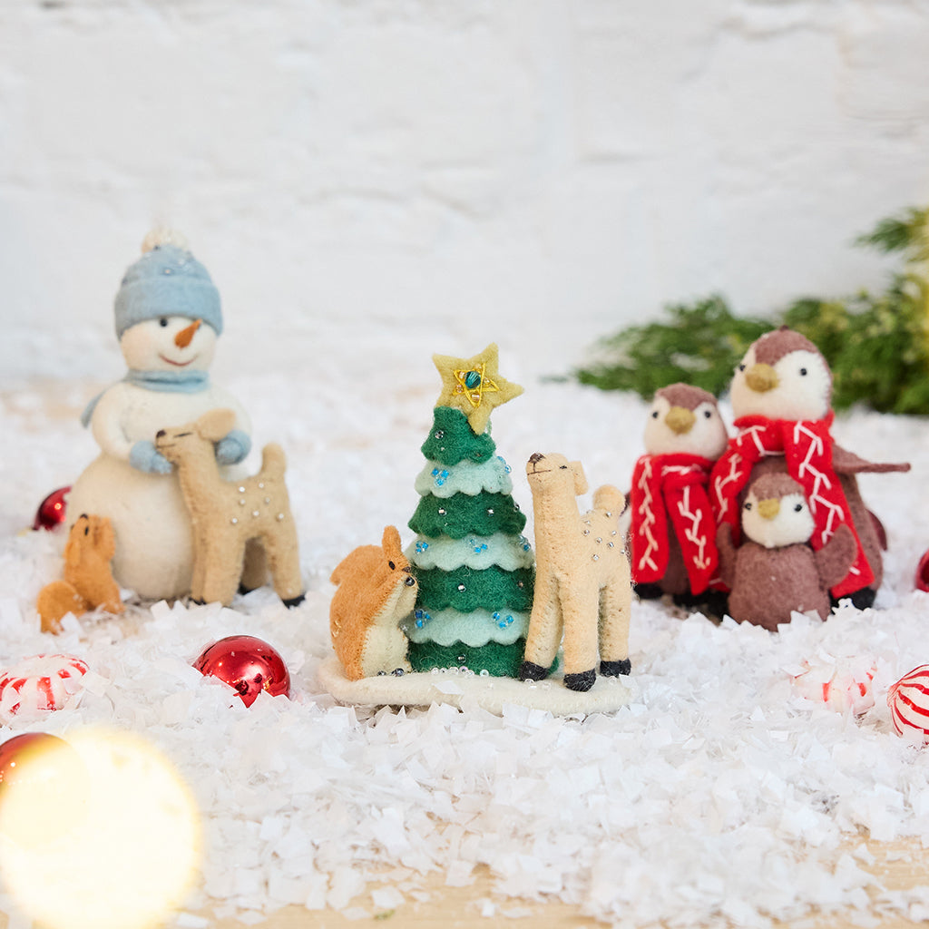 Craftspring’s Tender Woodland Ornaments Bundle — includes Snowman with Friends Ornament, Deer & Squirrel Decorating Tree Ornament, and Penguin Family Ornament — displayed together in a cozy holiday setting, highlighting sweet and tender designs with intricate beaded and embroidered details, evoking festive warmth and heirloom-quality Christmas gifting, ethically crafted by artisans using sustainable wool.