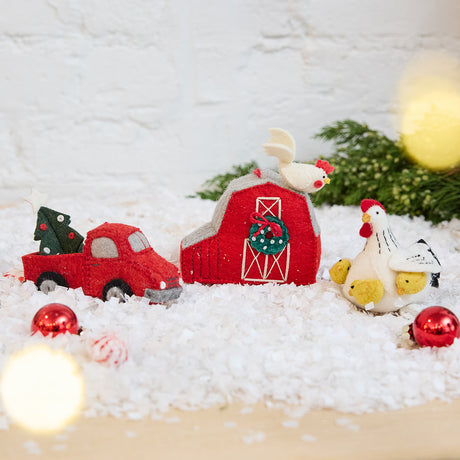 Craftspring’s Christmas on the Farm Ornaments Bundle — includes Mama Clucky the Hen with Chicks Ornament, Red Barn with Rooster Ornament, and Tree Farm Return Truck Ornament — displayed together in a cozy holiday setting, highlighting playful farm-themed designs with beaded and embroidered details, evoking festive warmth and heirloom-quality Christmas gifting, ethically crafted by artisans using sustainable wool.