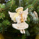 Vintage-Style Angel Playing Trumpet Ornament from Craftspring displayed on a Christmas tree — handmade felt ornament with sweet face and intricate beaded and embroidered details, depicting an angel playing a trumpet, ethically crafted by artisans using sustainable wool for festive holiday gifting.