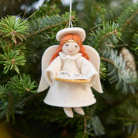 Vintage-Style Angel Singing Noel Ornament from Craftspring displayed on a Christmas tree — handmade felt ornament with sweet face and intricate beaded and embroidered details, depicting an angel singing Noel, ethically crafted by artisans using sustainable wool for festive holiday gifting.