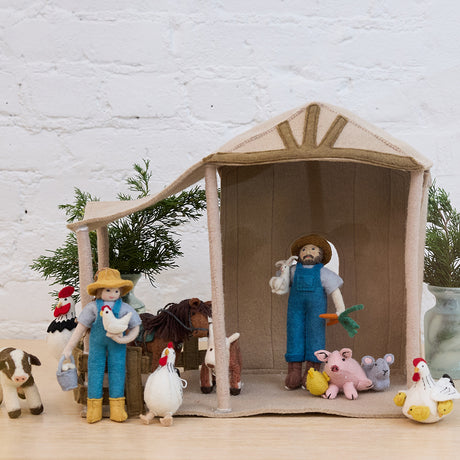 Nativity Barn displayed with Craftspring’s farmer and farm animal ornaments — handmade felt holiday decor designed to hold the Holy Night Nativity Scene, creating a festive Christmas scene, ethically crafted by artisans using sustainable wool.