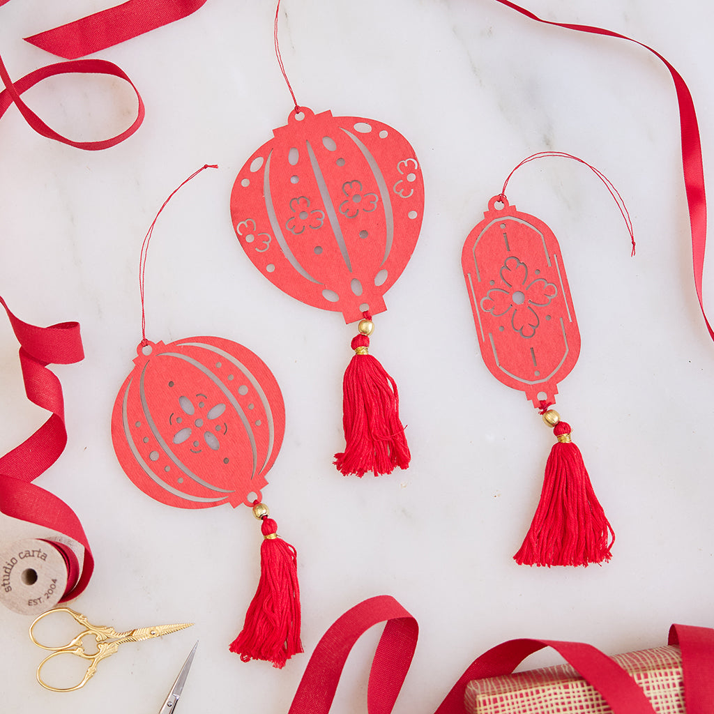 Paper Lantern Ornaments displayed with bright red ribbon, highlighting their festive paper craftsmanship. Ethically handmade by artisans for meaningful Lunar New Year celebrations.