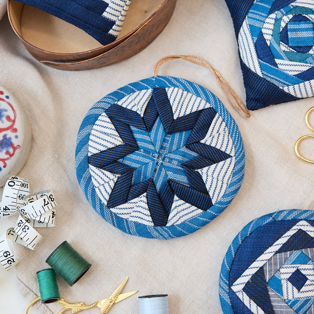 Indigo Quilted Ornament from Craftspring’s Set of 4 displayed among craft supplies—highlighting heirloom-quality quilting, festive holiday crafting, and thoughtful Christmas gifting, ethically handmade by artisans.