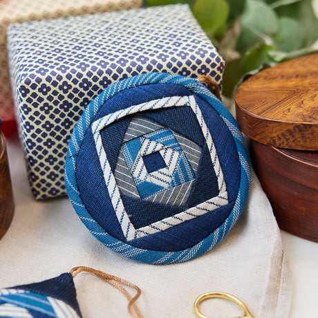 Indigo Quilted Ornament from Craftspring’s Set of 4 displayed among craft supplies—highlighting heirloom-quality quilting, festive holiday crafting, and thoughtful Christmas gifting, ethically handmade by artisans.
