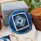 Indigo Quilted Ornament from Craftspring’s Set of 4 displayed among craft supplies—highlighting heirloom-quality quilting, festive holiday crafting, and thoughtful Christmas gifting, ethically handmade by artisans.