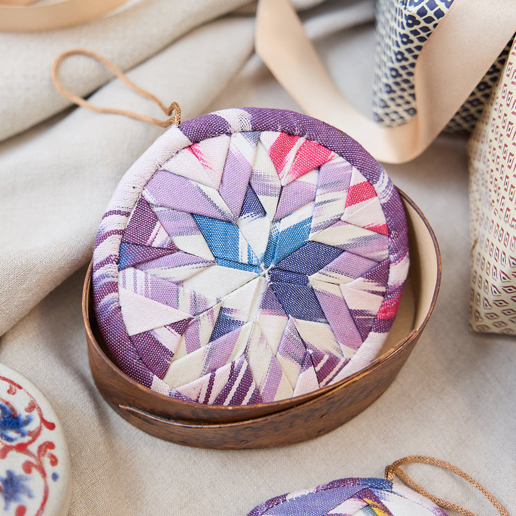 Ikat Quilted Ornament from Craftspring’s Set of 4 displayed among craft supplies—highlighting heirloom-quality quilting, festive holiday crafting, and thoughtful Christmas gifting, ethically handmade by artisans.