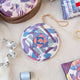 Ikat Quilted Ornament from Craftspring’s Set of 4 displayed among craft supplies—highlighting heirloom-quality quilting, festive holiday crafting, and thoughtful Christmas gifting, ethically handmade by artisans.