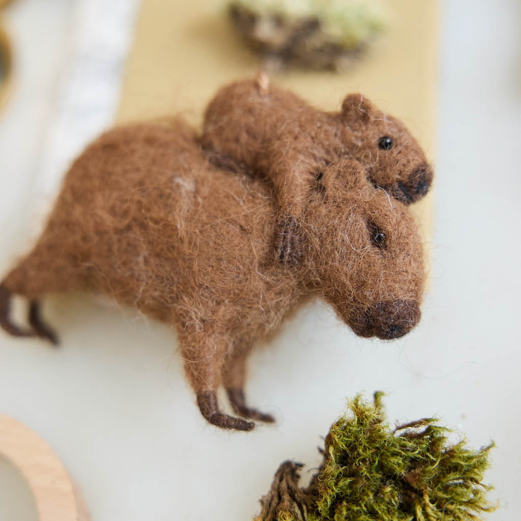A needle-felted alpaca wool capybara and baby ornament from Peru, symbolizing calm, nurturing love, and gentle family bonds—perfect for meaningful gifting and cozy decor.