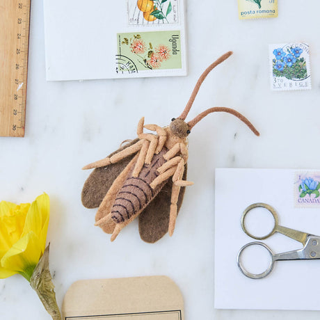 Celebrate one of nature’s most resilient and fascinating creatures with our Cockroach Ornament.  Lovingly needle-felted from natural wool, this tiny explorer features carefully stitched wings, long antennae, and a softly sculpted body that highlights the intricate beauty of this often-overlooked insect. 