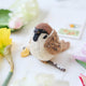 Celebrate the quiet beauty of everyday birds with our Sparrow Ornament. Small yet full of personality, this beloved garden bird is lovingly hand-felted from natural wool and perched on a delicate felt branch.