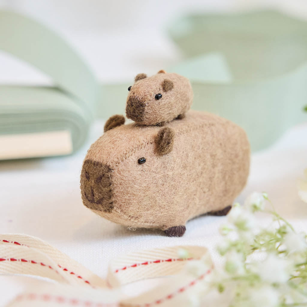 A handmade felt capybara and baby ornament from Kyrgyzstan. Cute as can be —perfect for meaningful gifting and cozy decor.
