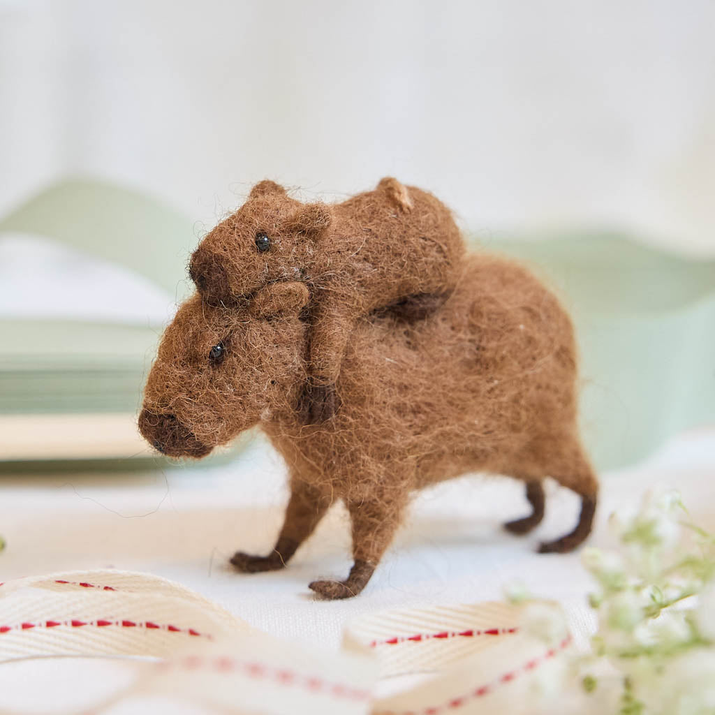 A needle-felted alpaca wool capybara and baby ornament from Peru, symbolizing calm, nurturing love, and gentle family bonds—perfect for meaningful gifting and cozy decor.