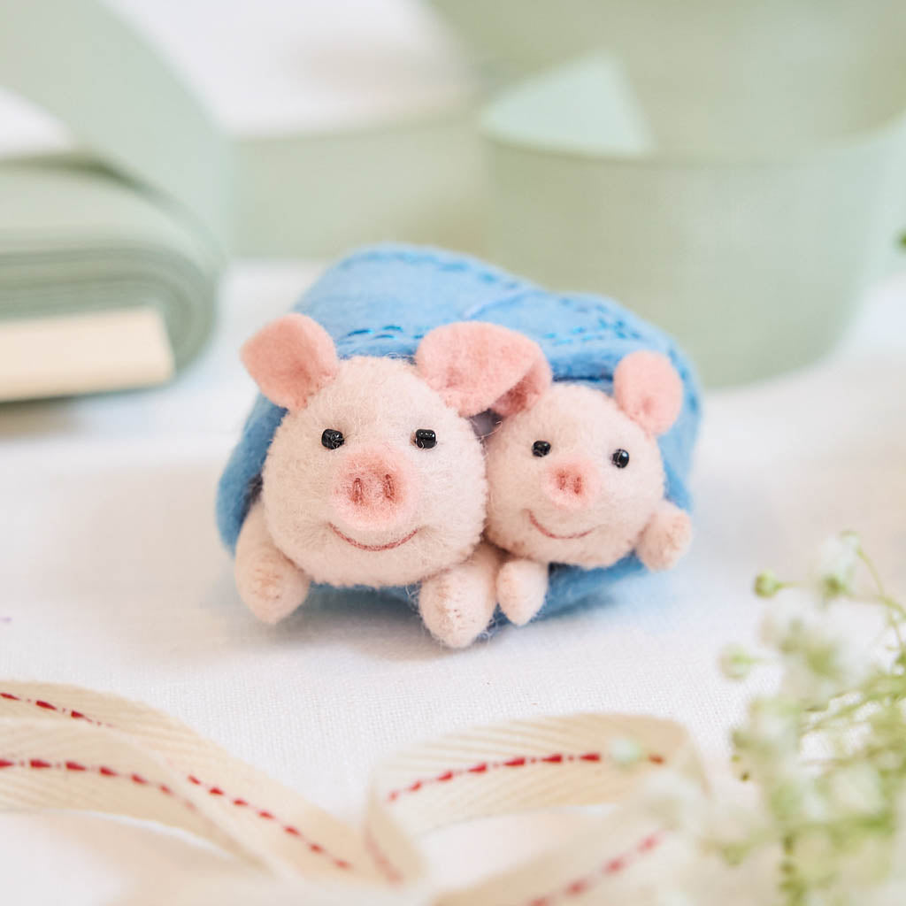 Cozy, cuddly, and completely irresistible—our Pigs in a Blanket Ornament is here to wrap your holidays in pure joy. Featuring a sweet pig parent and baby snuggled snugly inside a soft blue “blanket,” this playful design brings together comfort, humor, and heartfelt connection in the most delightful way.