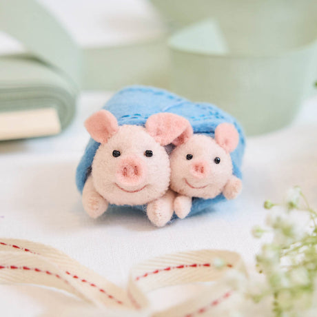 Cozy, cuddly, and completely irresistible—our Pigs in a Blanket Ornament is here to wrap your holidays in pure joy. Featuring a sweet pig parent and baby snuggled snugly inside a soft blue “blanket,” this playful design brings together comfort, humor, and heartfelt connection in the most delightful way.
