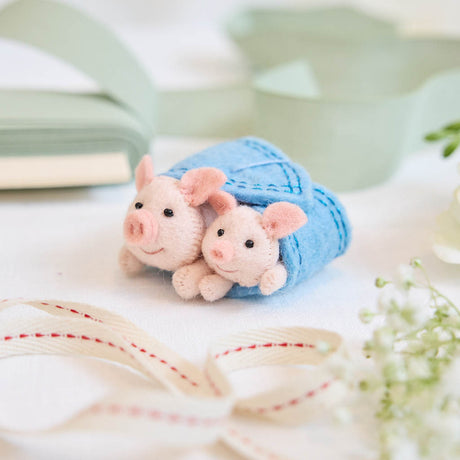 Cozy, cuddly, and completely irresistible—our Pigs in a Blanket Ornament is here to wrap your holidays in pure joy. Featuring a sweet pig parent and baby snuggled snugly inside a soft blue “blanket,” this playful design brings together comfort, humor, and heartfelt connection in the most delightful way.