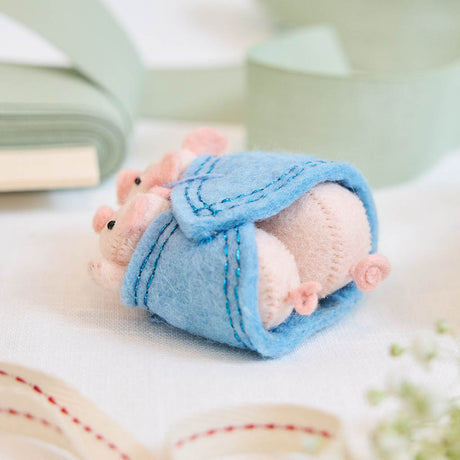 Cozy, cuddly, and completely irresistible—our Pigs in a Blanket Ornament is here to wrap your holidays in pure joy. Featuring a sweet pig parent and baby snuggled snugly inside a soft blue “blanket,” this playful design brings together comfort, humor, and heartfelt connection in the most delightful way.